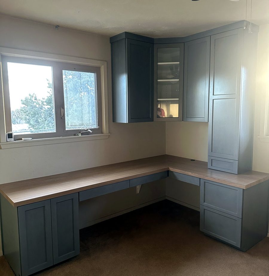 Corner home office with built-in desk and storage